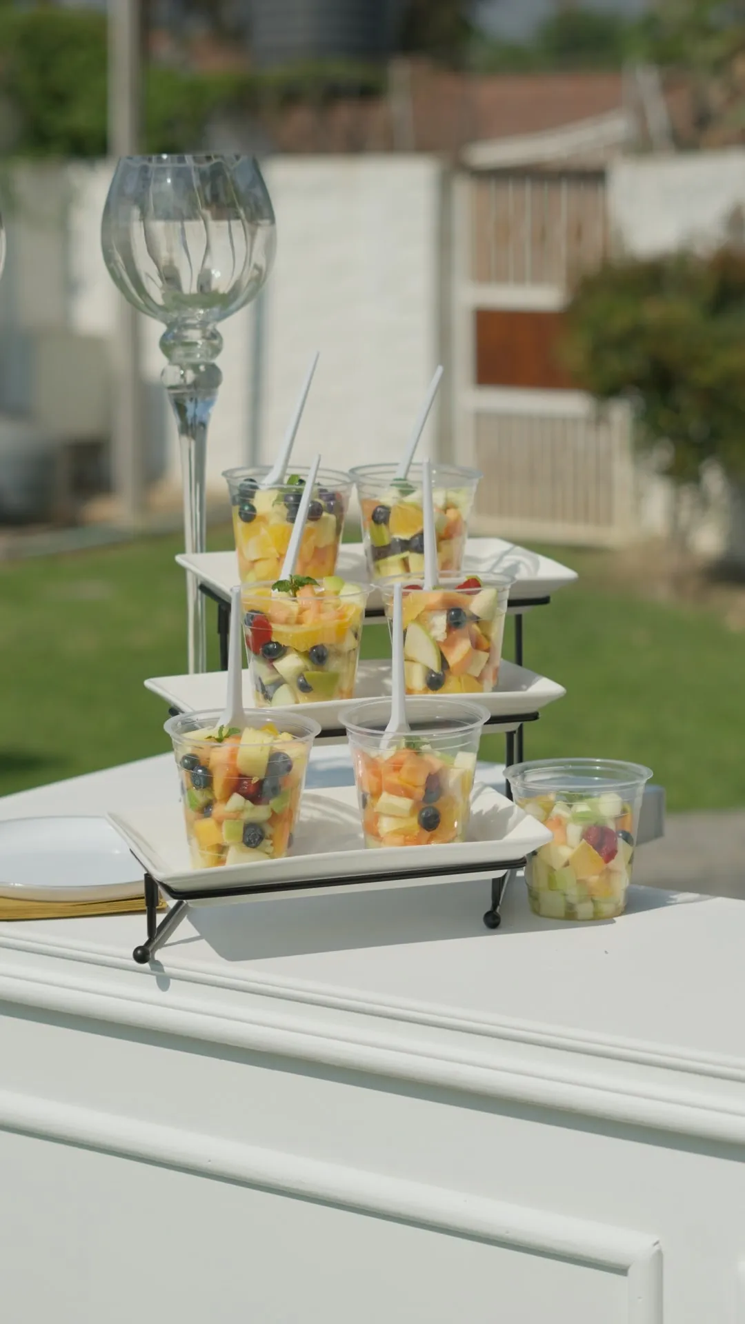 Individual fruit cups arranged on tiered stands on the KaizenCo Tapas cart